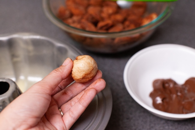 Easy Monkey Bread with Nutella from thelittlekitchen.net a hand holding Monkey Bread dough
