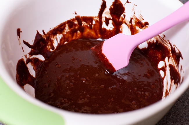 Heart Shaped Chocolate Cake from thelittlekitchen.net chocolate cake batter in a mixing bowl with a pink rubber spatula