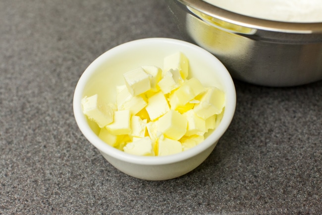Cubed pieces of butter in small white bowl Cubed pieces of butter in small white bowl