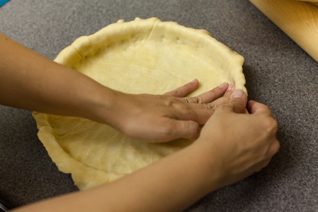 Hands pressing Sugar Pie dough into tart pan Hands pressing Sugar Pie dough into tart pan