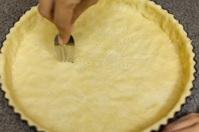 Using fork to poke holes in Sugar Pie crust dough Using fork to poke holes in Sugar Pie crust dough