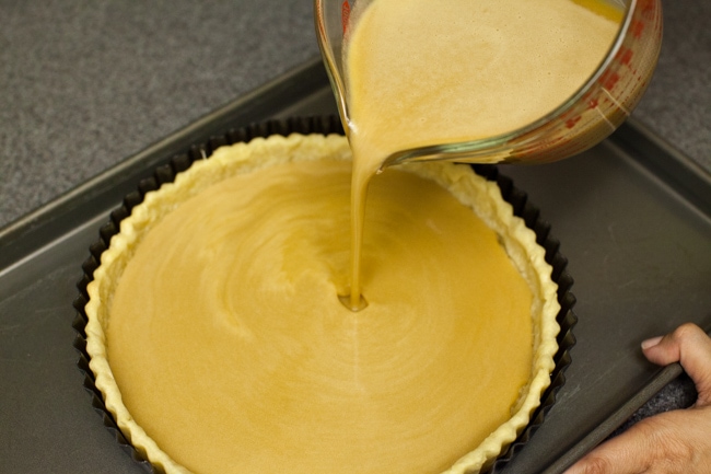 Pouring Sugar Pie filling into baked pie crust Pouring Sugar Pie filling into baked pie crust